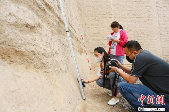 科技保護讓長城價值的真實性和完整性得到有效延續(xù)和傳承。圖為文物工作者正在測量關(guān)城的相關(guān)數(shù)據(jù)。　高展 攝